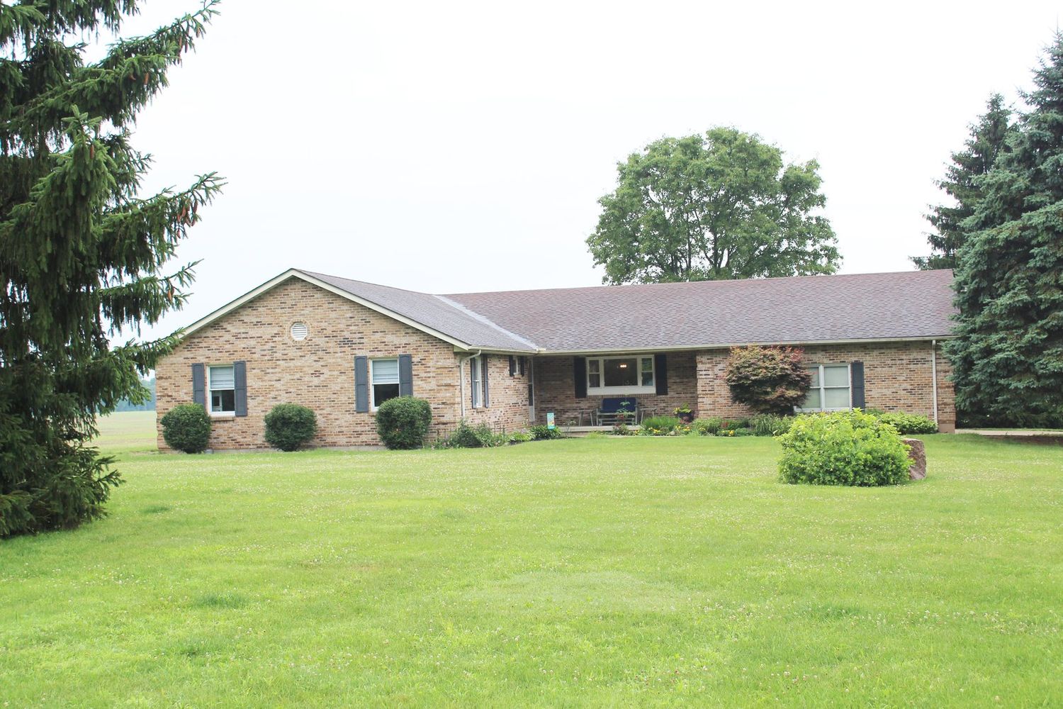The brick ranch home and grounds