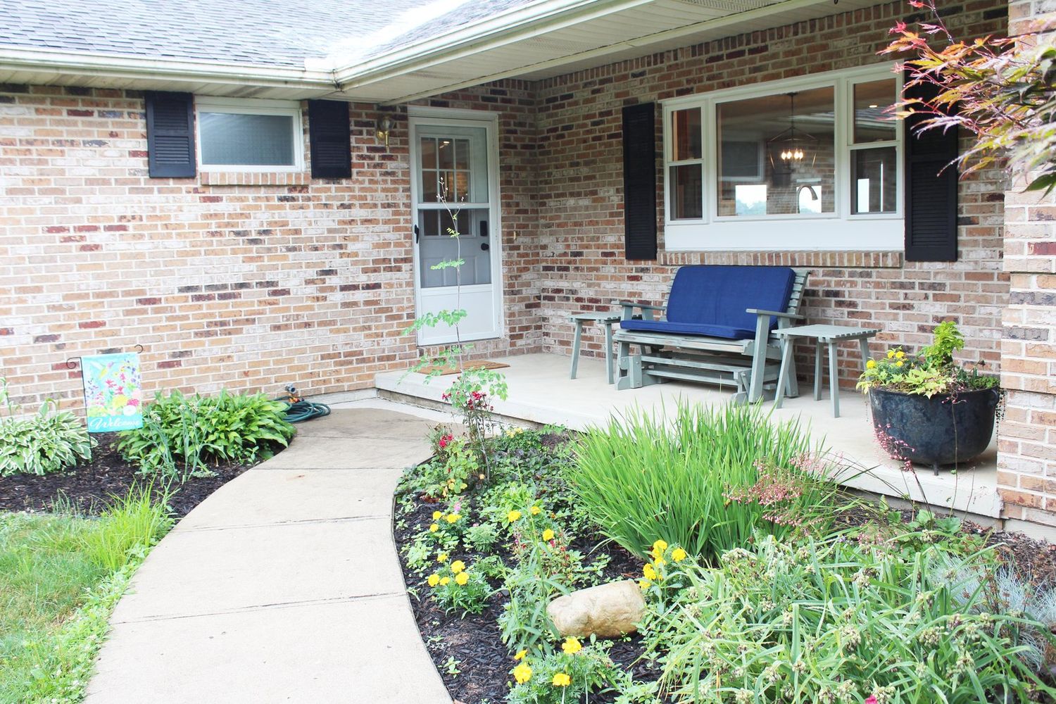 The welcoming front porch and gardens